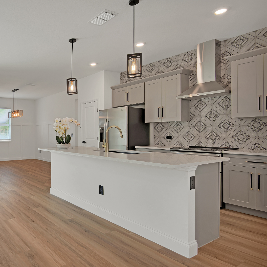 Modern remodeled kitchen with quartz island and pendant lighting